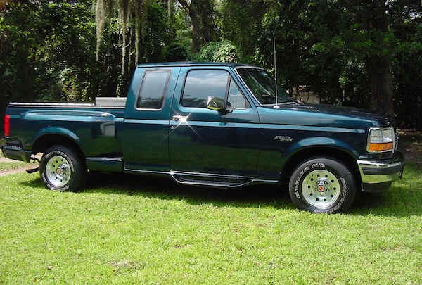 A dark teal, pristine F-150 truck