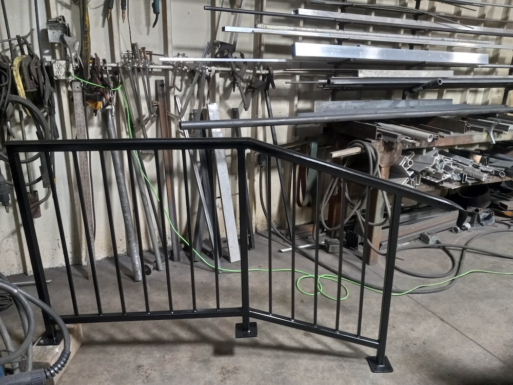 A black custom metal guardrail for stairs